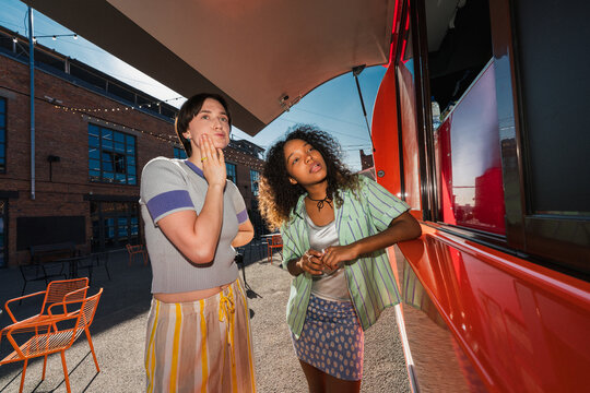 Friends ordering food at outdoor food truck