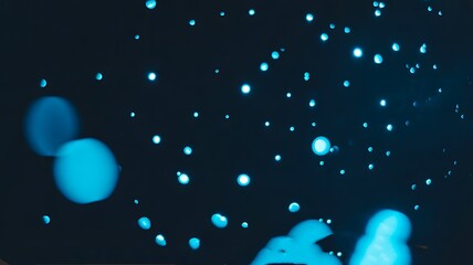 Fototapeta premium Abstract blue bokeh light background with glowing circles and soft focus effect 