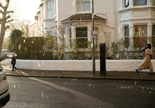Anonymous people walking in the rain