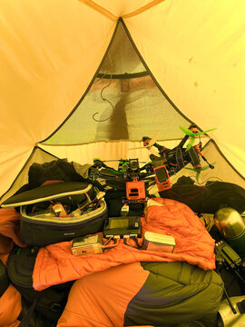 Drone gear and supplies inside alpine tent