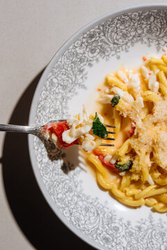 Seafood pasta with tomato, herbs, and grated cheese