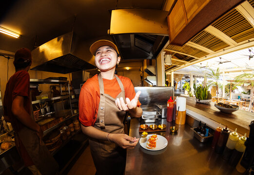 Portrait of smiling cook preparing dish