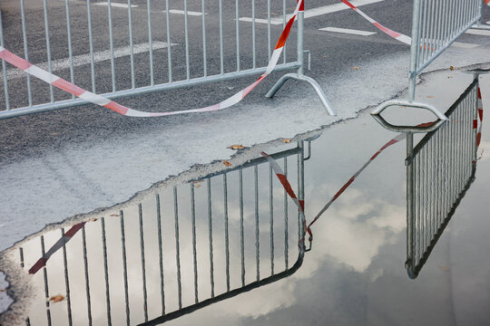 Barricade reflection in water puddle