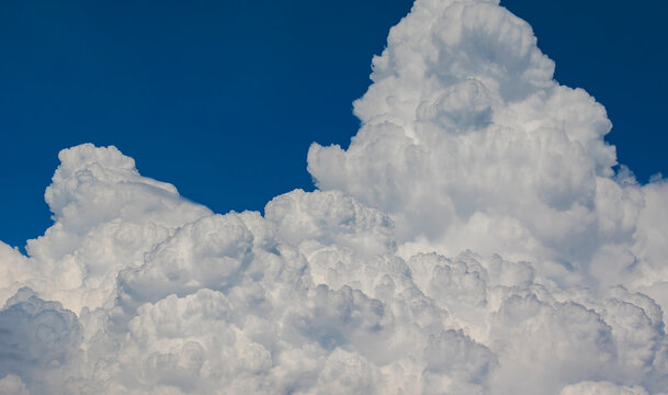 Mountains of the Sky: Magnificent Cumulus Clouds Under a Clear Sky.