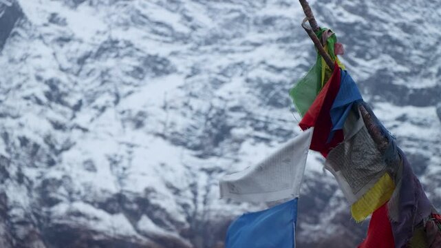 Colorful Tibetan Prayer Flags Fluttering in Wind with Snow Himalayas Background