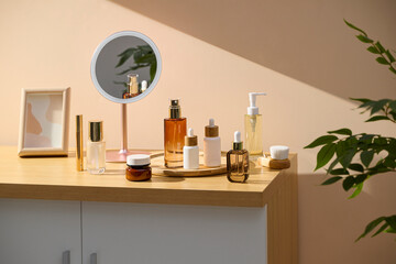 Cosmetics and skincare products arranged on a wooden cabinet