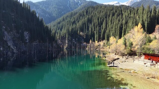 Lake Kaindy Aerial View &ndash; Turquoise Water and Mountain Valley.
Drone aerial shot of Lake Kaindy in Kazakhstan with bright turquoise water, forested slopes and rocky valley. Unique natural landscape.