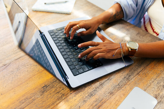 Anonymous person working on a laptop