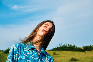 Young Man Enjoying a Breezy Day in a Grassy Field