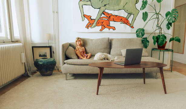 Kid watching cartoons on sofa