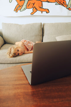 Kid watching cartoons on sofa