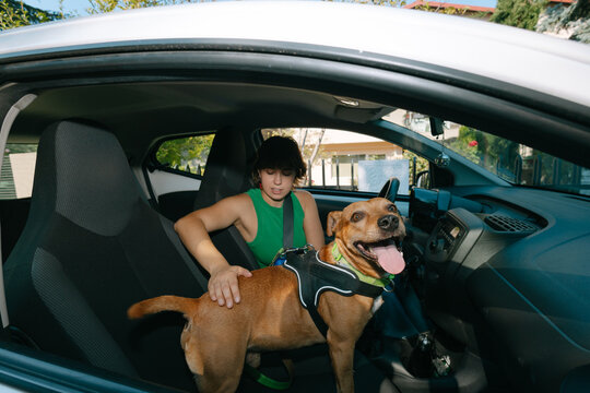 Woman and dog in car