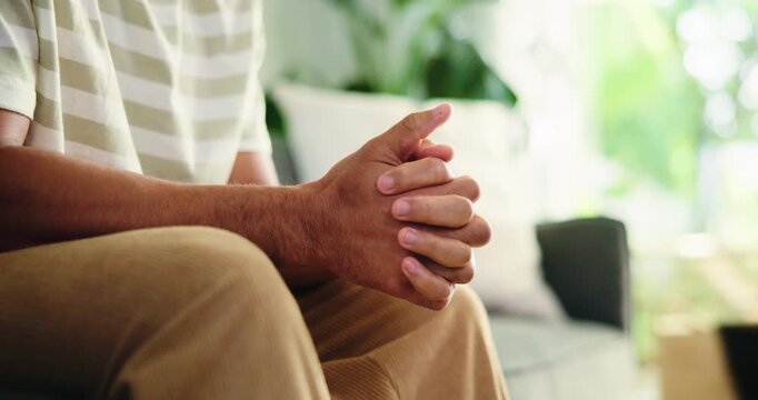 Counseling, hands and man on couch with anxiety, overthinking or coping mechanism for nerves. Mental health, space and client in clinic for consultation, trauma help and mistake in recovery.