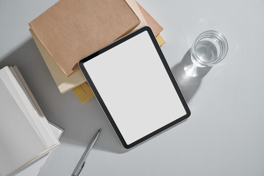 A modern workspace featuring a tablet with a blank screen