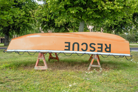 Rescue concept with overturned rowing boat on the shore