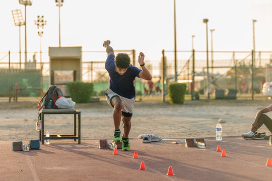 Young Omani Athlete Practicing Starting Blocks Technique on Track