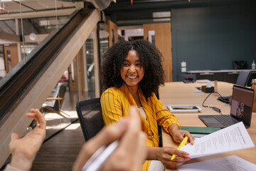 Smiling businesswoman in colorful outfit during collaborative session