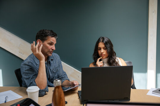 Two colleagues discussing project details during a collaborative chat