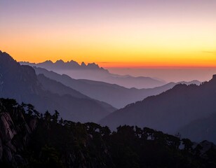 Serene mountain range silhouetted against a vibrant orange and purple sunset