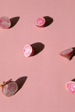 Conceptual image of circle root vegetables on pastel pink background 