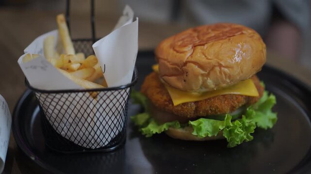 Burgers and fries served at the restaurant table and ready to eat