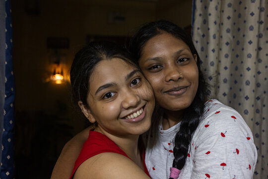 Two Young Indian lady looking at camera inside home, close up shot