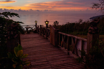 Wooden Deck Overlooking Ocean at Sunset