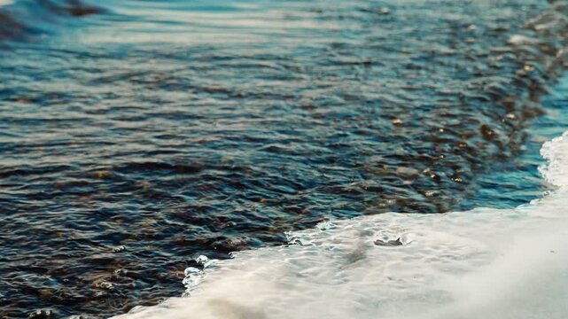 Coastal waves on the lake wash away the first ice that freezes on the shore at night. Sub-zero temperatures, the onset of winter cold.