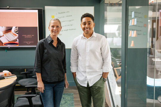 Business professionals posing in modern office interior