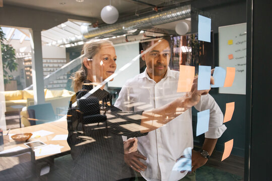 Professionals brainstorming with sticky notes in the office