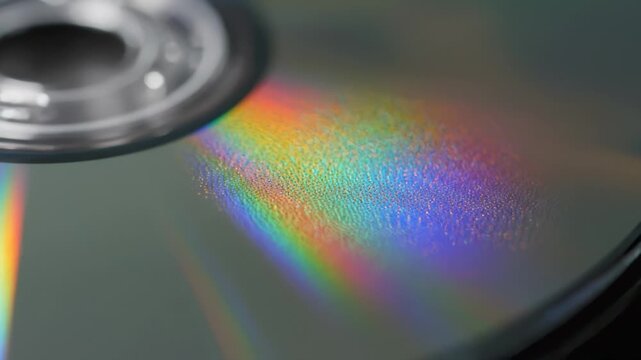 Close Up of Shiny Silver Cd Reflecting Rainbow Color Light Effect