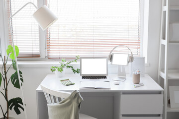 Fototapeta premium Modern home office workspace with laptop and tablet mockup screens, remote work and online learning setup