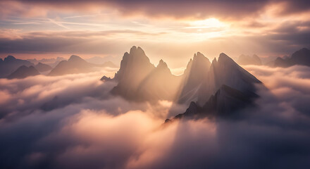Majestic mountain peaks emerging from a sea of clouds at sunrise