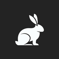 Abstract rabbit logo silhouette on black background, great for elegant minimalist design concepts.