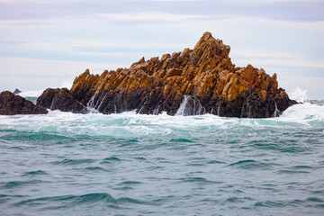 Fototapeta premium Dramatic coastal high power waves crashing over rocks - Atlantic Ocean, South Africa