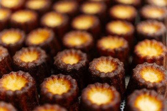 Close-up of baked caneles with caramelized crusts