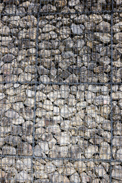 Stones behind a wire mesh