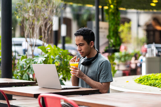 Content creator with laptop working outdoors