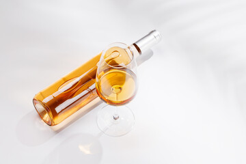 Fototapeta premium Rose wine bottle and glass on white background