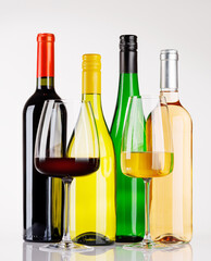 Fototapeta premium Different wine bottles and glasses on white background