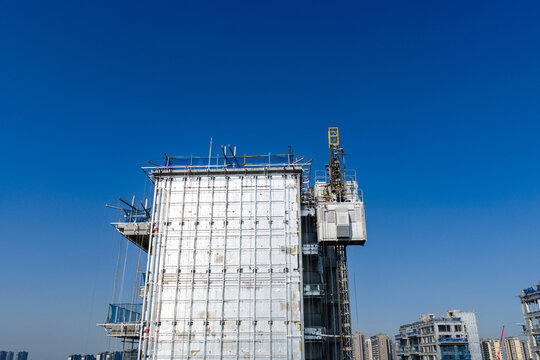 High rise building under construction with workers