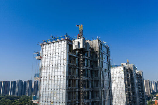 High rise building under construction with workers
