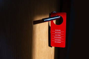 Do not disturb sign on hotel door handle