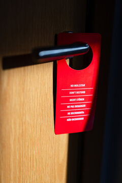 Red do not disturb sign on a modern door handle