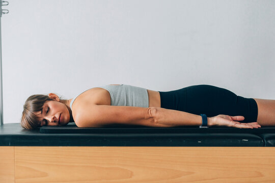 Young Woman Relaxing on a Flat Surface in a Restful Pose