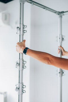 Close-Up of a Hand Gripping an Adjustable Metal Pole 