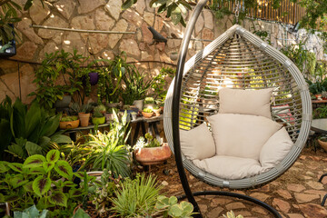 Cozy Swing Chair Surrounded by Vibrant Plants in a Garden Space