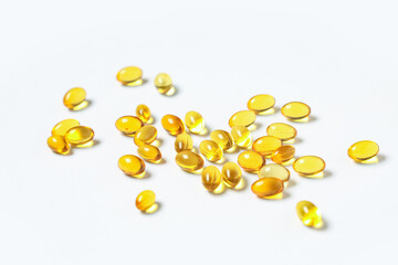 Vitamin E capsules on white background