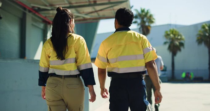 Walking, people and logistics team with discussion, supply chain planning or distribution. Warehouse, outdoor and workers in collaboration for shipping, export or point to storage facility from back - Powered by Adobe