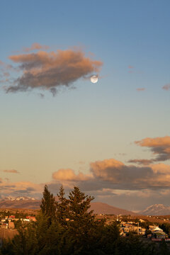 Full Moon Over Mountain Town at Sunset